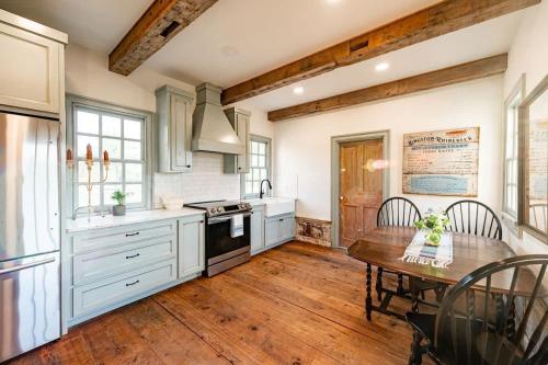 a kitchen with a wooden table and a wooden floor at Hudson upstairs suite - The Mohawk Valley House in Bellmead