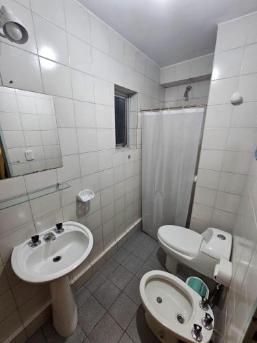 a bathroom with a sink and a toilet and a shower at En la cañada cerca de todo in Córdoba