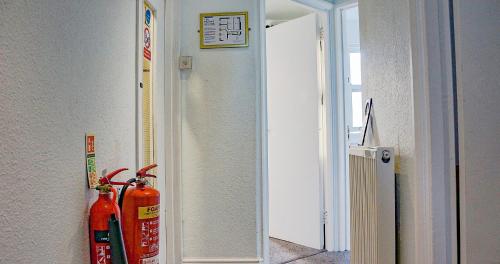 two fire hydrants are sitting next to a doorway at The Pier Hotel in Eastbourne
