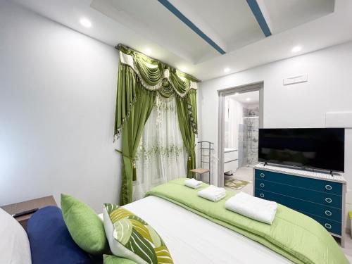 a bedroom with a large bed and a large screen tv at La Dolce Casa in Rome