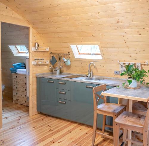 a kitchen with a sink and a table at Glamping Dragonja River in Šmarje
