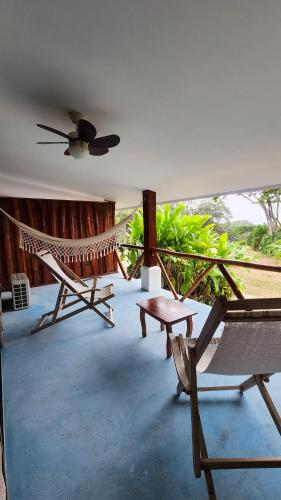 a room with a hammock and a chair and a table at La Puesta del Sol B&B in Carrillo