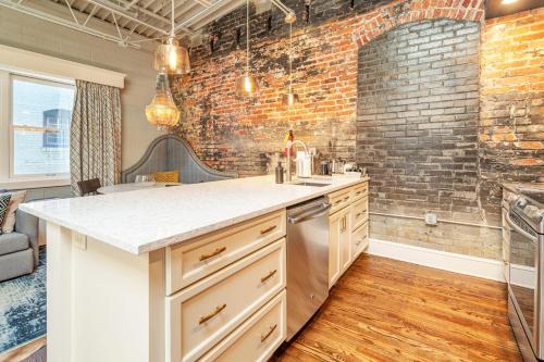 a kitchen with a counter and a brick wall at 80 Lex 203 Eclectic Industrial Apt in Asheville