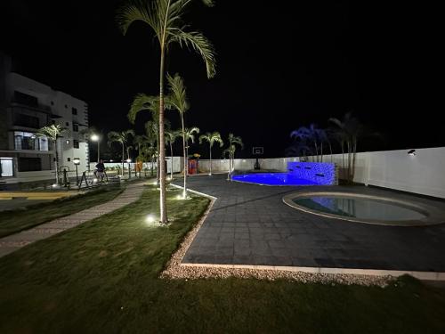 a skate park at night with a palm tree at RESIDENCIAL LEGADo in Azua de Compostela