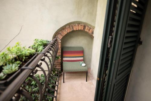 a chair sitting on a stairway at Suite n7 - Rifugio d'epoca con posto auto in Brescia