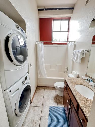 a bathroom with a washing machine and a sink at Sleepover 2BD 1BA Condos Downtown Springfield in Springfield