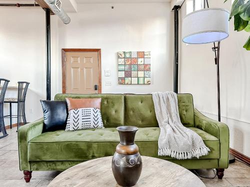 a green couch in a living room with a table at Sleepover 2BD 1BA Condos Downtown Springfield in Springfield