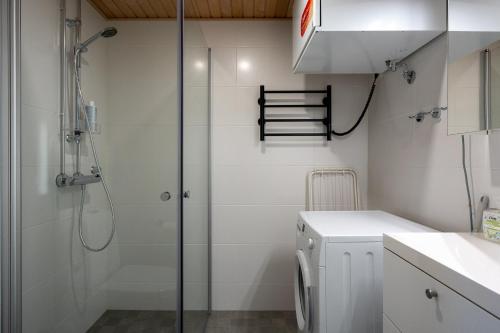 a shower in a bathroom with a glass shower stall at Easy Stay Rooms & Apartments near Airport in Vantaa