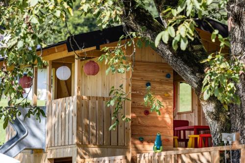 a wooden play house in a tree at Wassererlehen in Bischofswiesen