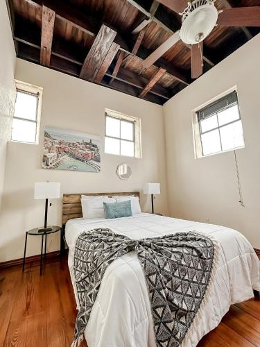 a bedroom with a large bed and two windows at Sleepover 2BD 1BA Condos Downtown Springfield in Springfield