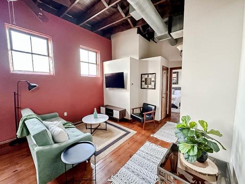 a living room with a couch and a tv at Sleepover 2BD 1BA Condos Downtown Springfield in Springfield