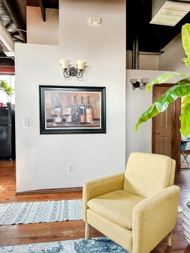 a living room with a chair and a picture at Sleepover 2BD 1BA Condos Downtown Springfield in Springfield