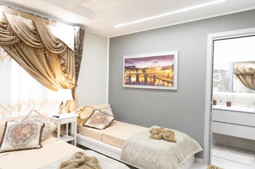 a bedroom with two beds and a window at La Dolce Casa in Rome