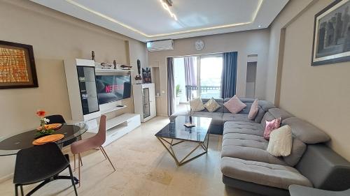 a living room with a couch and a table at Marina Panorama Apartement in Agadir