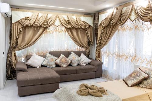 a living room with a brown couch and curtains at La Dolce Casa in Rome