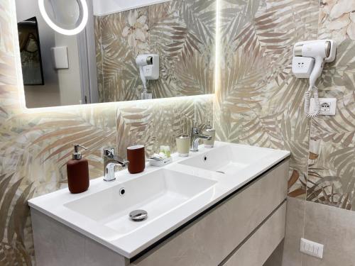 a bathroom with a white sink and a mirror at La Dolce Casa in Rome
