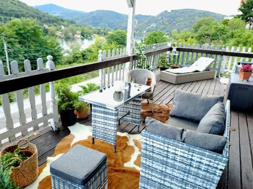 a patio with a table and chairs on a deck at Mountains Apartment Elb Canyon in Ústí nad Labem