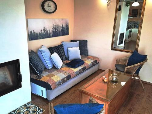 a living room with a couch with pillows on it at Mountains Apartment Elb Canyon in Ústí nad Labem