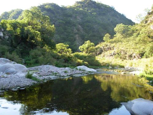 a river in the middle of a mountain at Hostería Villa Luz Habitación 1 in San Marcos Sierras