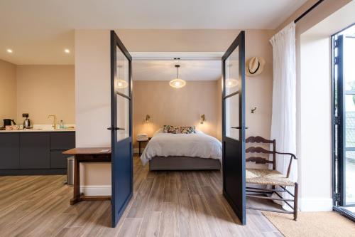 a bedroom with a bed and a table and a desk at Stunning detached house near Bruton in Shepton Mallet