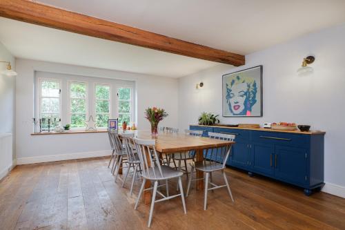 a dining room with a wooden table and chairs at Stunning detached house near Bruton in Shepton Mallet