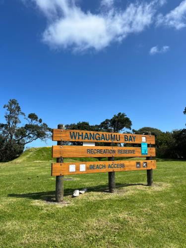 a sign for the watsonian bay prehistoric preserve on a field at Tutukaka Sunrise in Tutukaka