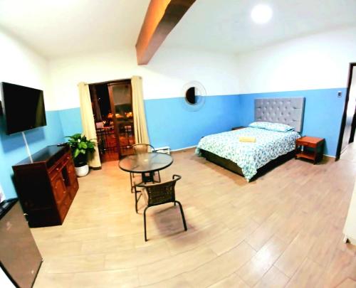 a bedroom with a bed and a table and a tv at Miraflores Kennedy Park in Lima