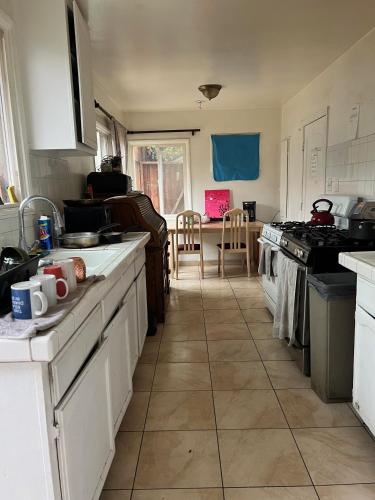 a kitchen with white cabinets and a stove top oven at Timen House in North Hollywood