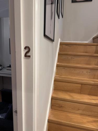 a stairway with the number on the wall at Modern Comfort En-Suite Room 2 in Oxford
