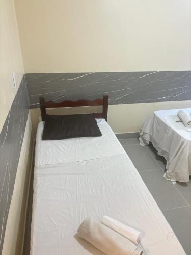 a bedroom with two beds with towels on them at H one Hotel in Goiânia