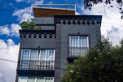 a tall building with windows on the side of it at Reforma Guest House in Mexico City
