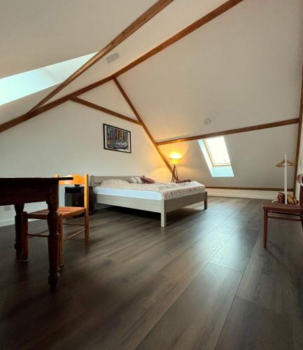 a bedroom with a bed in a attic at Mazurskie Energie dom ekologiczny całoroczny in Stare Juchy