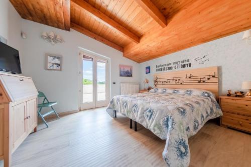 a bedroom with a bed and a wooden ceiling at Villa Le Cicale - Irpinia in Prata di Principato Ultra