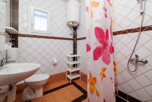 une salle de bains avec toilettes et lavabo dans l'établissement Apartments Grga, à Lopar