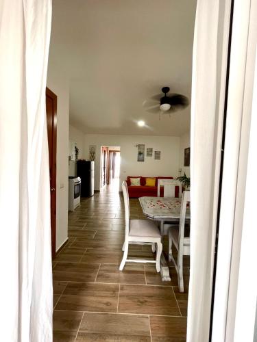 a dining room and living room with a table and chairs at Charming Bayahibe condo with pool and beach in Bayahibe
