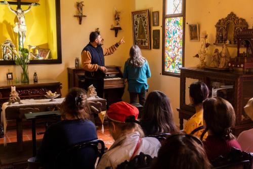 a man standing in a room with a group of people at Hacienda San Isidro Trails & Experiences in Cotacachi