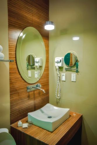 a bathroom with a sink and a mirror at Hotel Maioris La Paz in La Paz