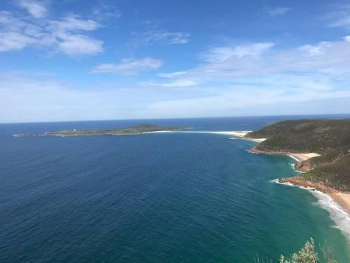 an aerial view of an island in the ocean at Shoal Vibes in Shoal Bay