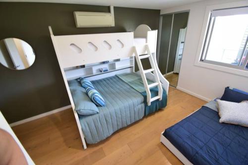 a bunk bed in a room with a bunk bed at Shoal Vibes in Shoal Bay