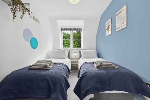 two beds in a room with blue and white walls at NEC Birmingham Airport Modern Village Retreat, Sleeps 7, Free Parking in Hampton in Arden