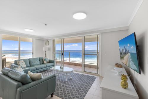 a living room with a couch and views of the ocean at Viscount on the Beach in Gold Coast