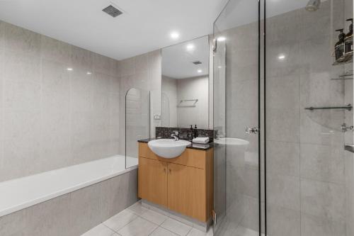 a bathroom with a sink and a shower at Viscount on the Beach in Gold Coast