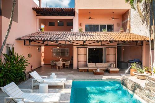 a patio with a swimming pool and a house at Casa Bella Cruz in Cruz de Huanacaxtle