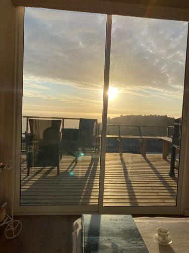 a view of the sun setting from a deck at Mar&cielo in Zapallar