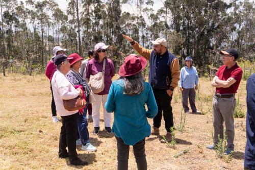 a group of people standing in a field at Hacienda San Isidro Trails & Experiences in Cotacachi