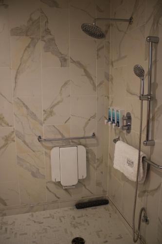 a shower in a bathroom with a marble wall at Sooke Harbour House in Sooke