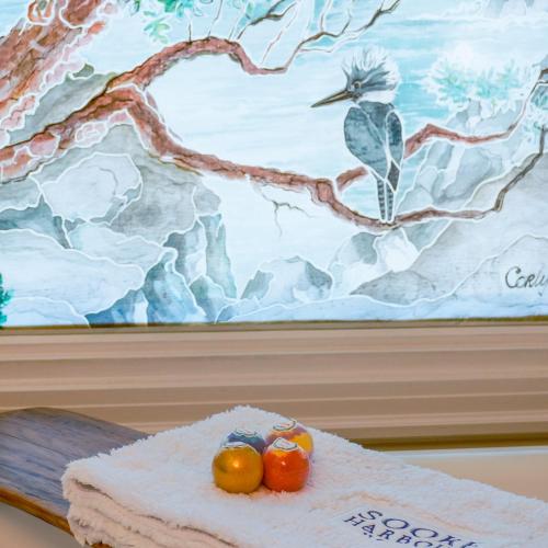 two rubber ducks sitting on a table in front of a painting at Sooke Harbour House in Sooke