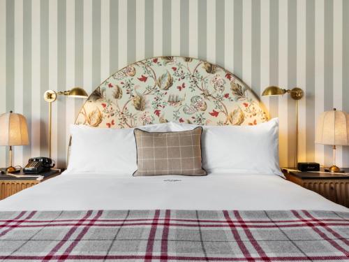 a bedroom with a large bed with a floral headboard at Le Petit Pali Brentwood in Los Angeles