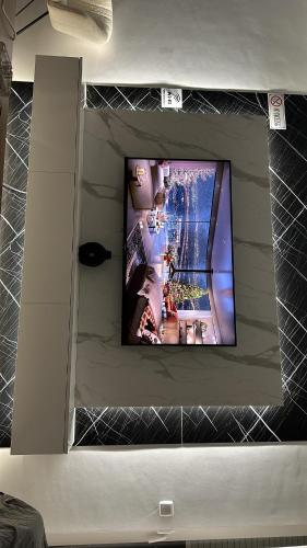 a flat screen tv on a wall in a room at BT Apartments in Kosovo Polje