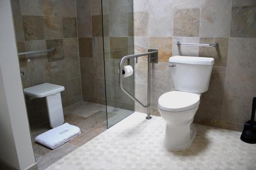 a bathroom with a toilet and a glass shower at Sooke Harbour House in Sooke